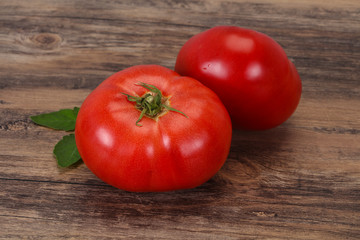 Ripe tomato over wooden background