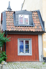 Traditional wooden house painted in traditional red located in Stockholm, Sweden