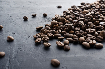 Closeup of scattered coffee beans on the black background