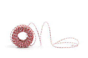 Red and white bakers twine rope spool isolated on white background. Packaging equipment or handicraft tool concept.  - Image