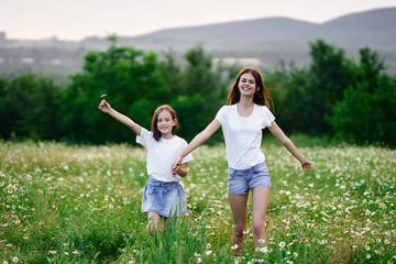 Fototapeta premium mother and daughter having fun in the field