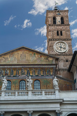 Fototapeta na wymiar facade of the Cathedral of the Blessed Virgin Mary the Great with a beautiful clock tower in the Italian capital