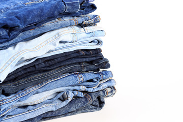 Stack of jeans pants on white background - Image