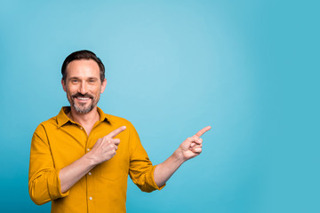 Portrait of positive man promoter point index finger copyspace indicate ads promo wear casual style...