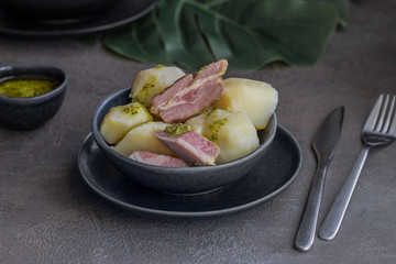 .Famous Canarian dish Papas con Costillas (Ribs and potatoes), served with mojo verde (green souse).It is authentic local food of Canary islands. .