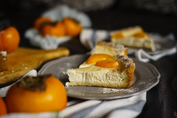 original persimmon cheesecake. Beautiful dessert on a gray background. New Year. Christmas. Halloween Thanksgiving Day
