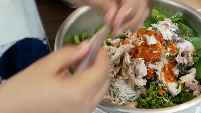Close up of fried mackerel served with fresh vegetable with shrimp-paste sauce, Mieng Plaa Too, being prepared - delicious Thai food