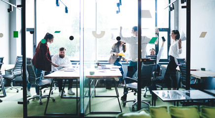 Cheerful colleagues in modern glass office