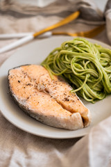 salmon steak and vegetable spaghetti. close-up. Vegetarian food. 