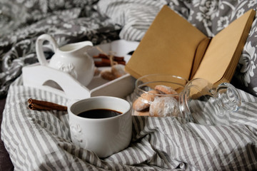 coffee with a book in bed. interior details. Scandinavian style.
