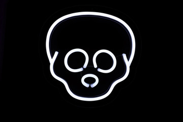 White skull neon sign on isolated black background. Neon concept. Modern style. Neon sign.