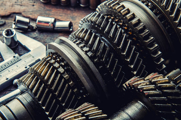 Engine gear wheels, industrial on wooden background. Top view - vintage film grain filter effect styles