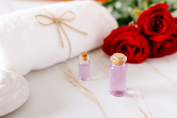 Obraz na płótnie Canvas Spa bath product with rose oil and.Rose petals on a white background.