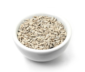 sunflower seeds in a white bowl isolated on white