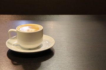 cup of coffee on wooden table
