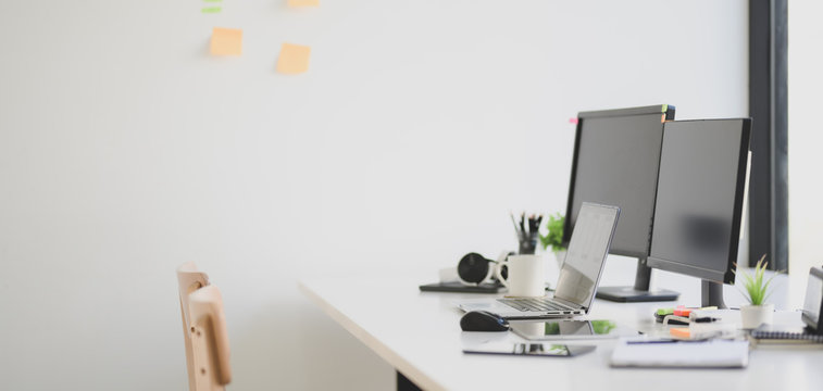 Cropped shot of modern office room with desktop computer and office supplies