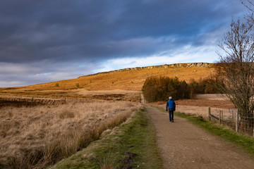 Fototapeta na wymiar Male rambler on footpath in Peak District, Derbyshire, UK