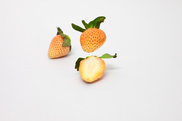 Cut strawberries isolated on white background. Studio shot of 2 pink plant. freshness fruit object. half and full piece of strawberry. sliced,