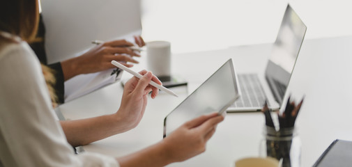 Cropped shot of young professional businesswomen working on their project together in modern office