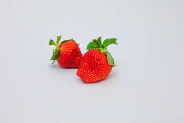 Cut strawberries isolated on white background. Studio shot of 2 red plant. freshness fruit object. half and full piece of strawberry. sliced,