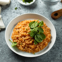 Homemade tomato risotto with fresh spinach