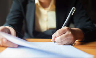 Business signing. A close-up of a businesswoman who signs a contract.