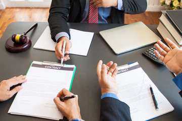 Contract signing. Businessman had doubts at the meeting to sign a legal agreement contract. The lawyer is explaining and answering the questions of the businessman.