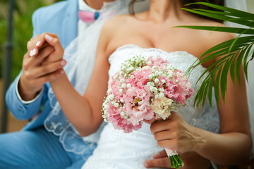 Obraz na płótnie Canvas wedding background: the bride holding wedding bouquet