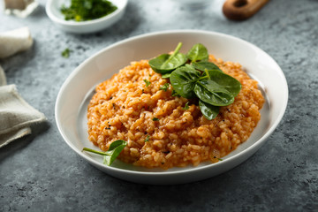 Homemade tomato risotto with fresh spinach