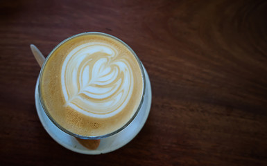 Latte coffee on wooden background