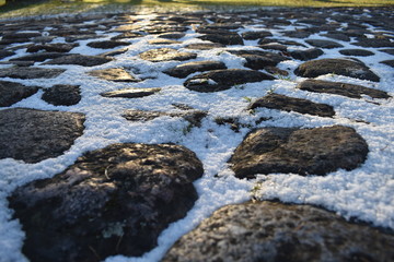 snow on cobblestone