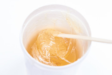Hair removal at spa luxury studio. Wax Shugaring. Hot sugar. Product waxing bowl. Salon jar