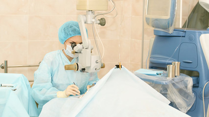Ophthalmology laser microscope operation. Doctor in clinic. Patient eye treatment. Myopia and...