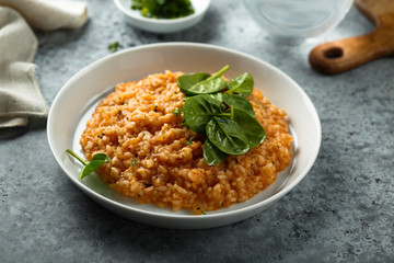 Homemade tomato risotto with fresh spinach