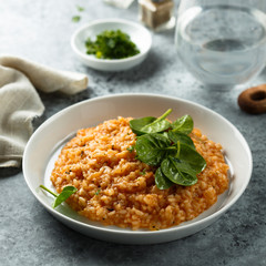 Homemade tomato risotto with fresh spinach