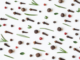 Creative decorative food composition of various spices and fresh herbs on white background.