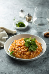 Homemade tomato risotto with fresh spinach