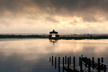 Fototapeta premium Local port in sunrise time for tourist services on a travelling to see the beautiful landscspe and lifestyle of people in the Inle Lake, Myanmar