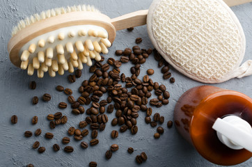 Top view of coffee beans, shower brush and sponge, cosmetic dispenser of moisturizer.Concep of natural peeling treatments