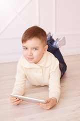 Naklejka premium Little boy. Bright interior. Modern training. Vertical