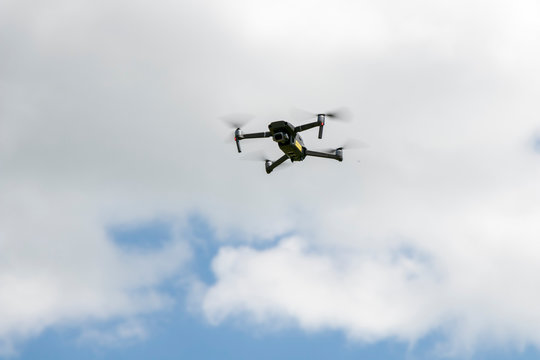 close up of drone for photography in the blue sky and white clouds.  