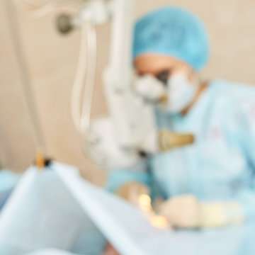 Ophthalmology laser microscope operation. Clinic room with doctor and parient. Blur background. Unfocus, selective focus