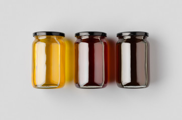 Three honey jars mockup on a grey background.