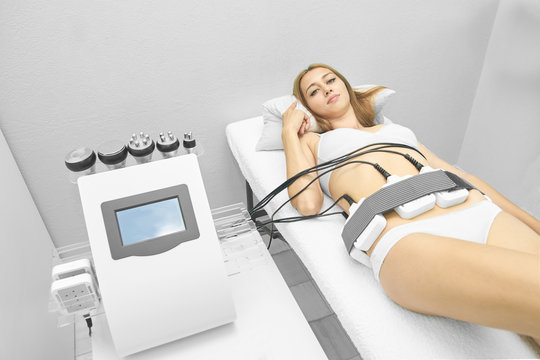 Laser lipo equipment. Cosmetic fat reduce treatment. Woman in medicine salon. Anti cellulite procedure