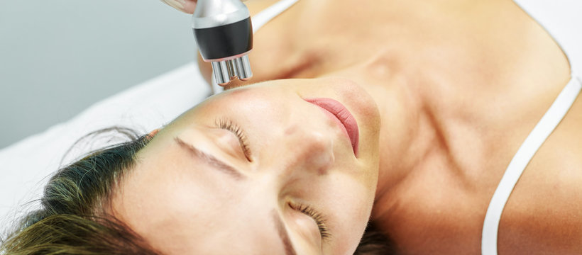 Dermatology skin care facial therapy. Medical spa anto wrinkles procedure. Woman face rejuvenation. Pretty girl. Rf cosmetician equipment