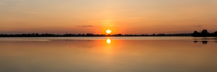 Panoramic beautiful view of sunset over the lake