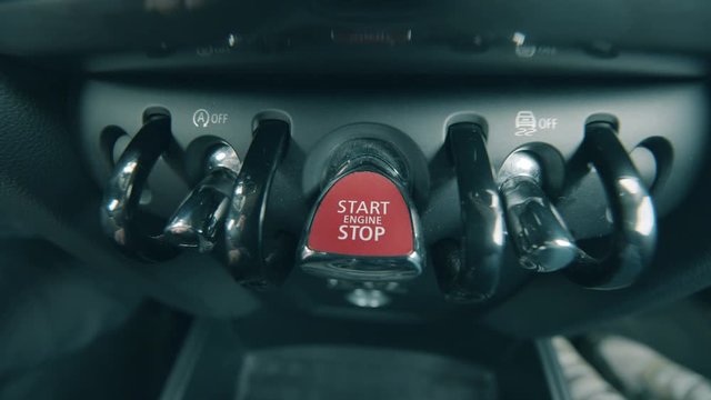 Car's dashboard with a start stop engine button on it