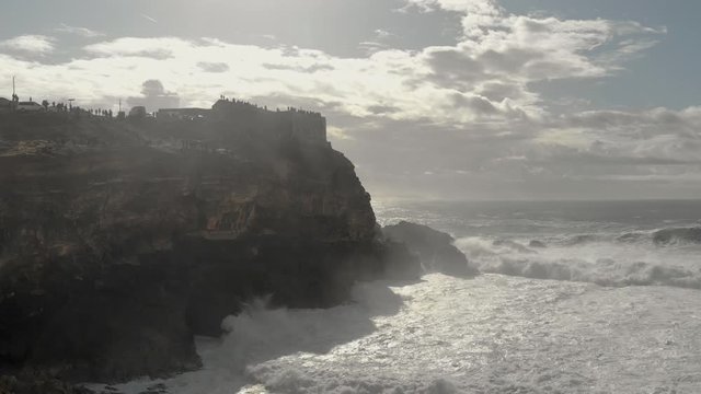 Nazare cliffs and lighthouse, giant waves aerial and drone footage, portugal, surfing hot spot