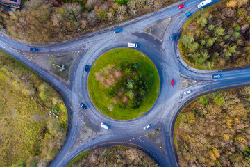 Top down aerial view of a traffic roundabout on a main road in an rural area of the United Kingdom