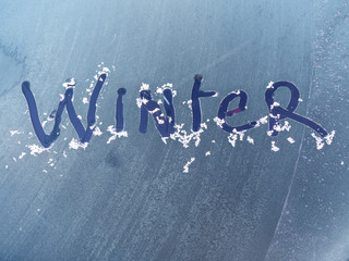 Winter written in the ice on a car windscreen on a cold frosty morning